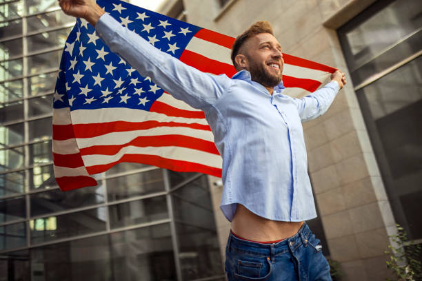 istock Young handsome man running with American flag 1403872237