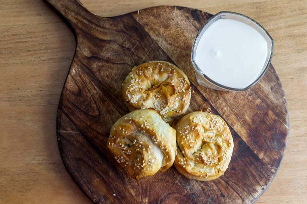 istock Baked twisted patties with dock and white cheese served for consumption 1403872325