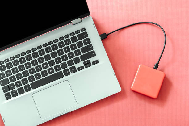 istock top view power bank laptop red background 1403872440
