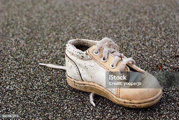 Baby Shoe On Beach Stock Photo - Download Image Now - Baby Booties, Lost, Abandoned