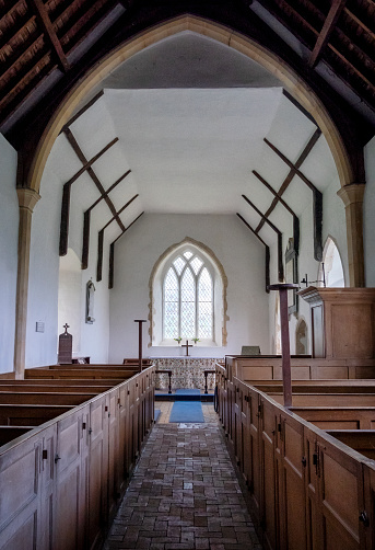 The beautifully simple Victorian interior of All Saints Church in Ramsholt, Suffolk, Eastern England. The church dates from Norman times but was derelict by the mid-19th century. The old box pews face the pulpit rather than the altar - the Word being more important at the time than the Sacrament.