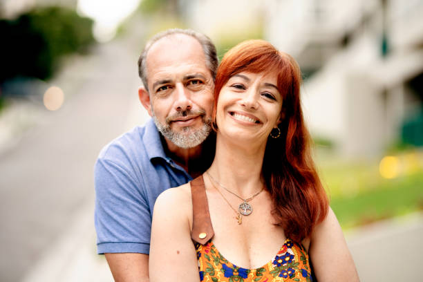 istock Affectionate mature couple standing arm in arm outside in summer 1403874517