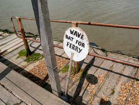 A message on the bat used to summon the ferryman when he is on the other side of the Deben estuary in Suffolk, eastern England. The ferry plies between Felixstowe Ferry and Bawdsey, across the River Deben.