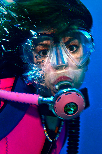 15 August 2005: Scuba diver Sally Herschorn poses for a photo in thirty feet of water at La Machaca Reef off the coast of Bonaire, in the Netherland Antilles. Housing used was an Aquatica D100 with flat port. Lighting with a single Ikelite 225s strobe at 1/4 power setting. Mandatory Photo Credit: Ed Wolfstein Photo