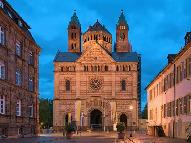 Speyer, Germany. West facade of Speyer Cathedral at sunset. The Imperial Cathedral Basilica of the Assumption and St Stephen was founded in 1030 and consecrated in 1061.