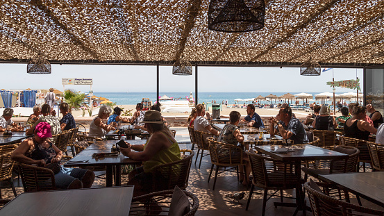 Torremolinos, Spain, June 12, 2022; View of the popular Mediterranean resort of La Carihuela from a cozy beach restaurant.