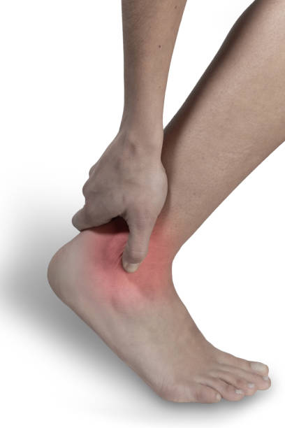 istock Ankle pain with hands covering it. Close-up 1403878835