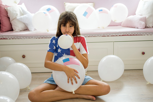 Cute girl with American Flag balloon