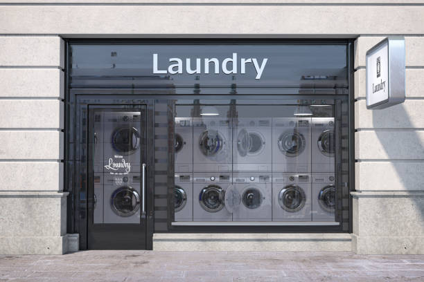 Laundry building exterior with washing machines inside it. stock photo