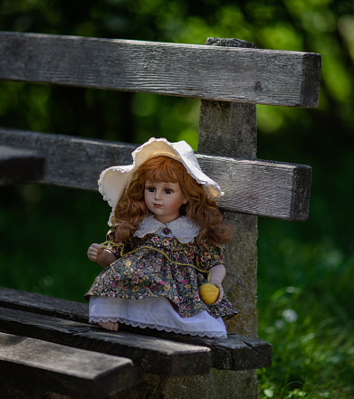 Amazing realistic vintage porcelain doll, toy with brown eyes, selective focus