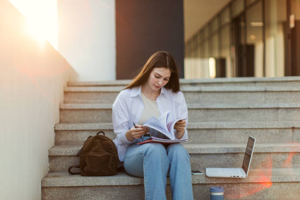 istock Female student is learning in front of university building 1403884764