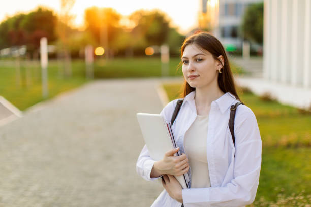 istock Portrait of female student holing lap top 1403885165