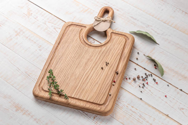istock square wooden cutting board with a handle and spices on a white background. mockup with copy space for text, side view 1403885170