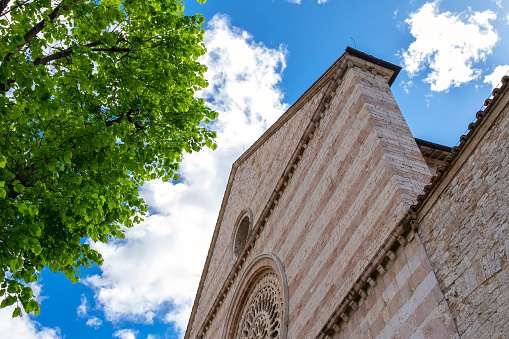 Perspective view of the St. Chiara church facade, in the old city centre of Assisi Umbria Region, central Italy. Is world famous as St. Francis birthplace Christian Italy’s Saint Patron.