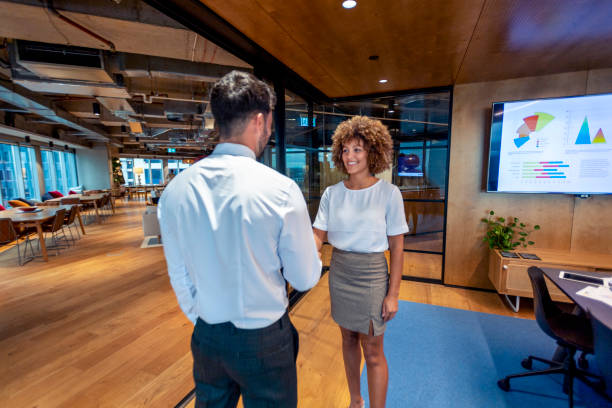istock Man and woman handshake in a board room. 1403889102