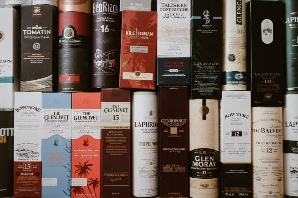 Whisky Calgary, Alberta - June 19, 2022: Single malt scotch whisky display boxes and tubes as background. bowmore whisky stock pictures, royalty-free photos & images