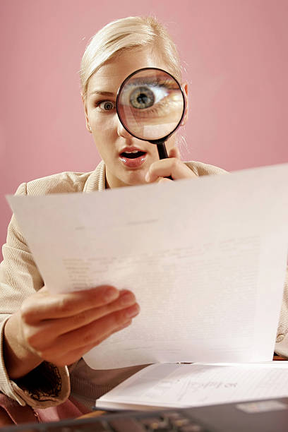 istock woman with a magnifying glass 140388951