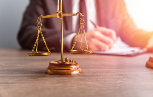 istock scales and lawyer working on papers 1403890640