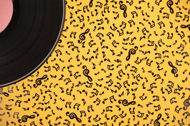 Musical pattern Musical composition. Vinyl record and black music notes on a yellow background orchestra photos stock pictures, royalty-free photos & images