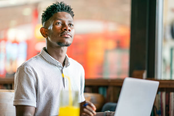 istock Man working on laptop at cafe 1403891847