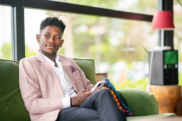 istock Black Businessman using mobile phone at lobby 1403892001