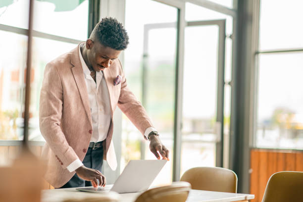 istock African Businessman working remote with portable devices 1403892024