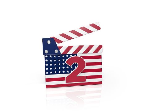 Movie clapper number two and the American flag on white background. Horizontal composition. Isolated with clipping path.