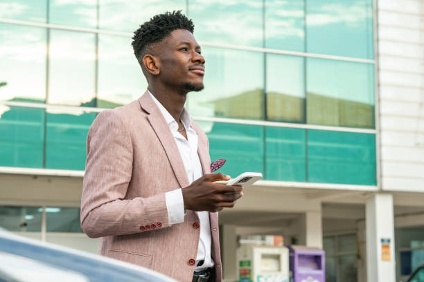 istock Businessman using mobile device in city street 1403893558