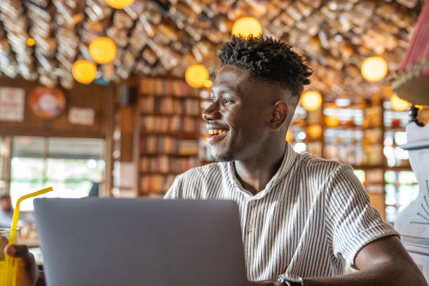 istock Young man working on laptop at cafe 1403894251