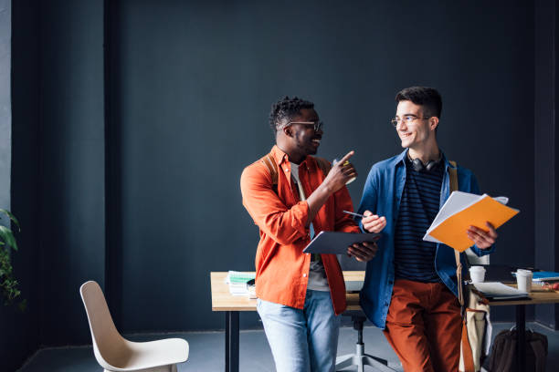 istock Two Happy Friends Talking And Having Fun In The Library 1403896702