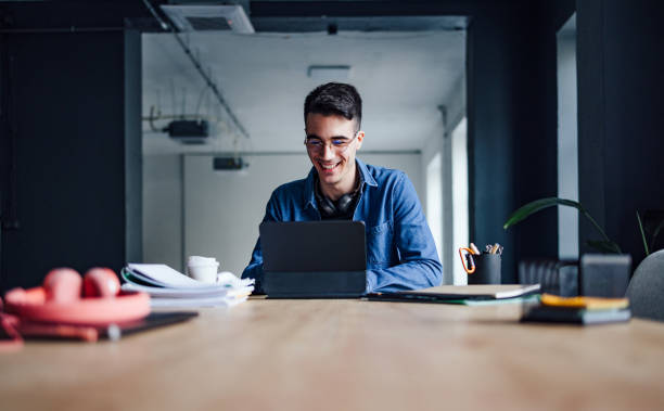 istock Happy Student Studying Online On His Digital Tablet In The Library 1403897271