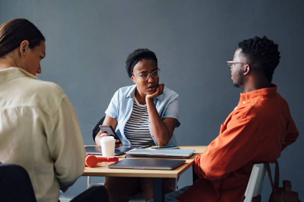 istock Three Friends Studying Together In The Library 1403897384