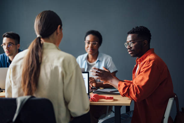 istock Four Friends Studying Together In The Library 1403897406