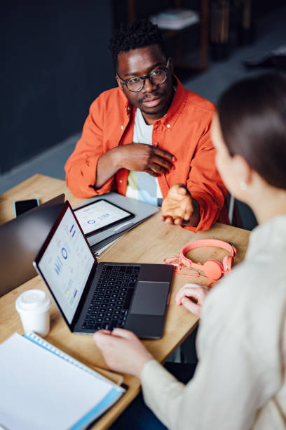 istock Two Friends Studying Together In The Library 1403897430