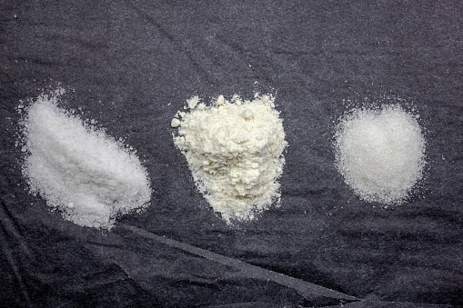 The Heaps of salt, flour and sugar. Salt flour and sugar close-up.