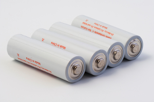 3D rendering of batteries in all sizes, isolated on white background.