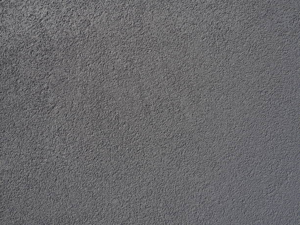istock Gray background. Neatly plastered gray or black wall. Rough texture. Velvety effect. Professional finishing of walls, interiors, facades of buildings and premises. Construction and design. 1403910428
