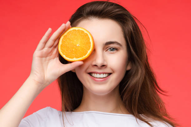 istock Cheerful young blonde posing with fresh oranges 1403910456
