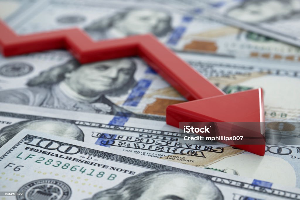 Economic Recession and Market Crash Concept USA enters a bear market and recession concept image of crashing arrow on one hundred dollar bills. US Paper Currency Stock Photo