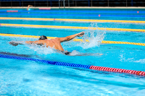 Shot of a young female swimmer doing the front crawl stroke