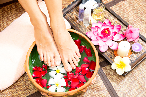 Spa treatment and massage product for female manicure foots skin care with white flower.