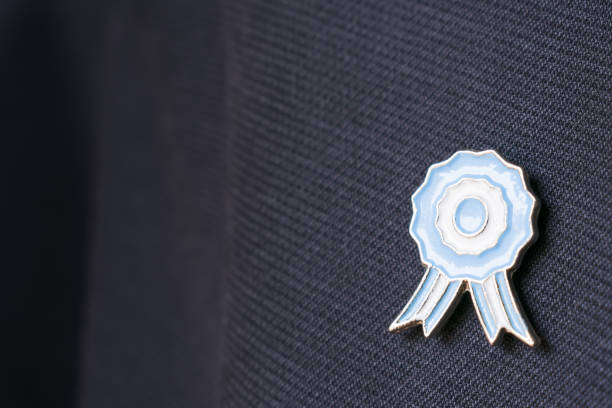 Argentina flag lapel metal pin on blue background. Copy space concept