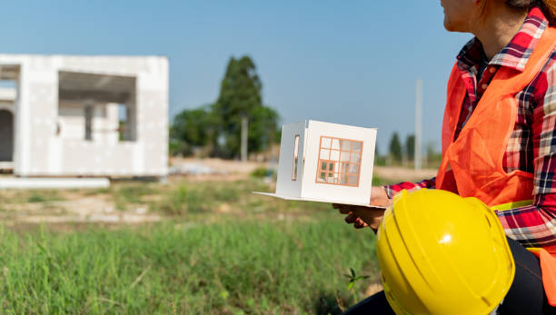 istock Engineering and architect woman working with house model at the construction property site. 1403920973
