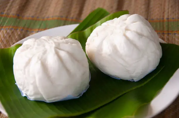 Photo of Malaysian Traditional steam buns on banana leaf. Asian food concept