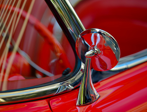 Classic retro beautiful red car. Close up mirror.