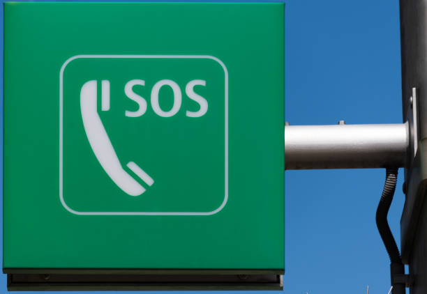 Sos phone or helpline for people in personal crisis - unrecognizable man with old red phone in hand