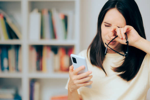 istock Woman Checking Smartphone Rubbing her Dry Eyes 1403926808