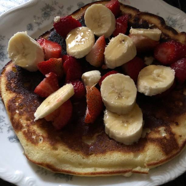 istock Pancake with banana and strawberries with syrup 1403927622
