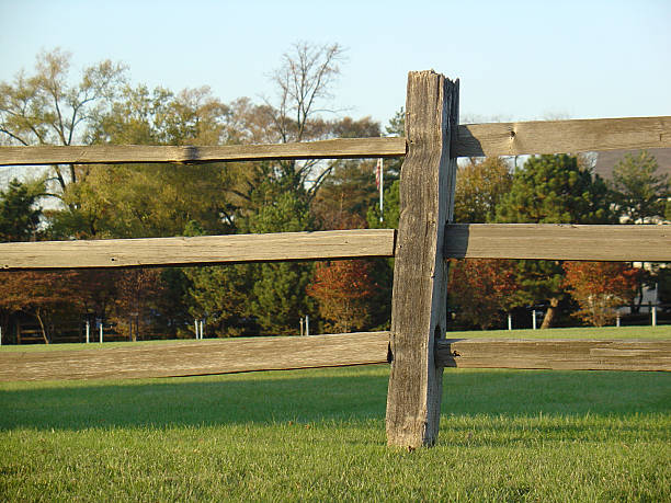                                Wooden fence with autumn trees in the background.