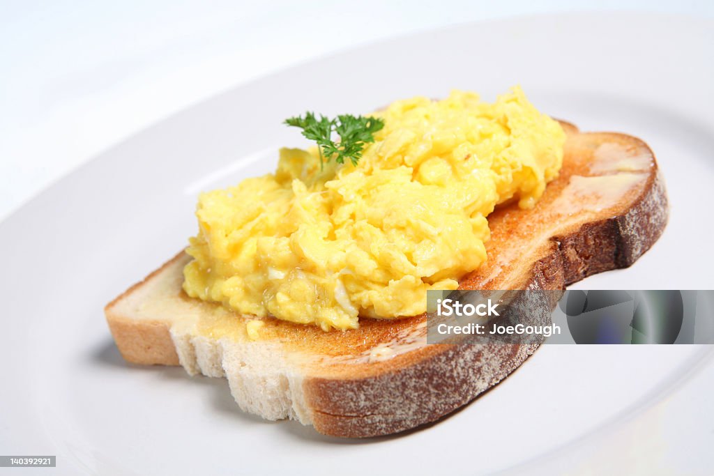 Scrambled eggs sitting on top of toast Scrambled free-range eggs on warm buttered toast. Bread Stock Photo